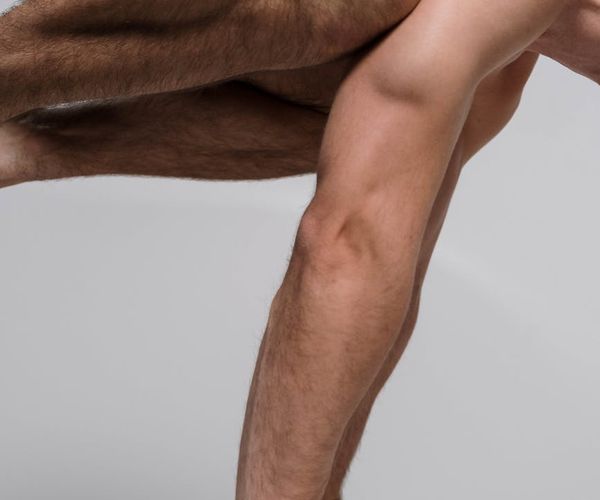 A focused man balancing during a core strength exercise in a calm environment.
